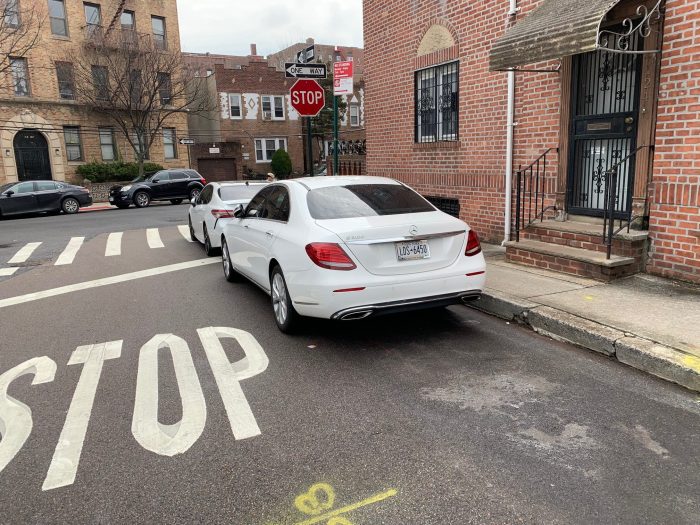 Surprising DOT report shows intersection safety may not improve much by banning parking near corners 3 cars parked near a DOT sign near a crosswalk