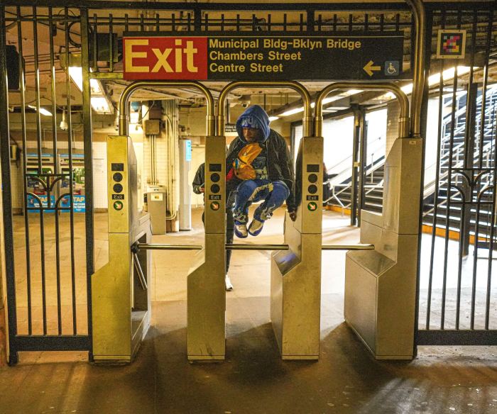 person jumping a subway turnstile 