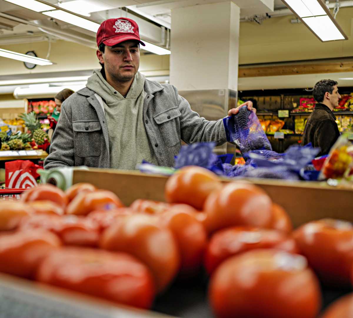 New York shopper looks at tomatoes amid concerns about tariffs and grocery costs