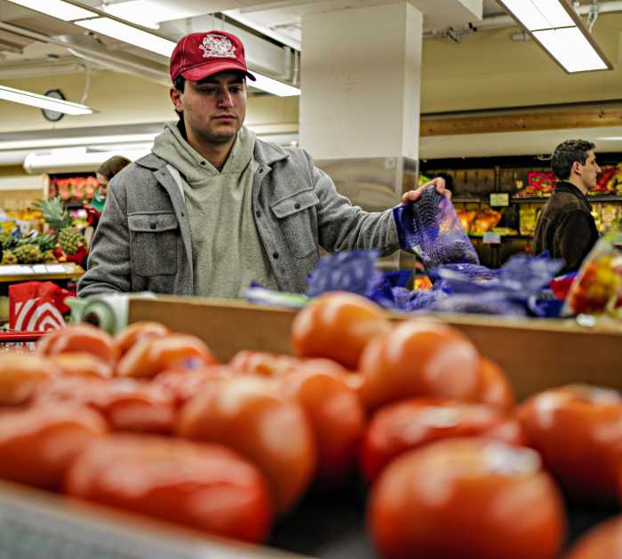 New York shopper looks at tomatoes amid concerns about tariffs and grocery costs