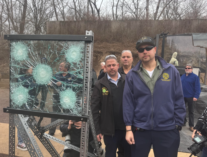 people outside near a bulletproof glass display