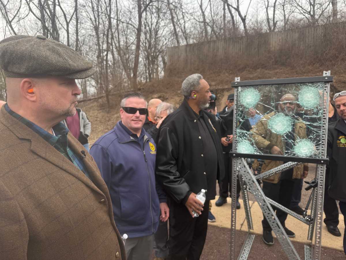 group of people outside at a demo of bulletproof glass