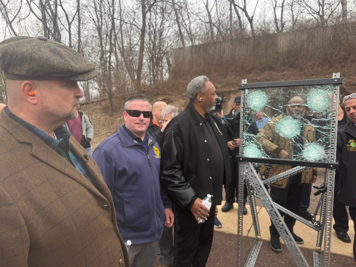 group of people outside at a demo of bulletproof glass