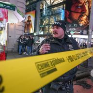 Police officer in Times Square investigating arson attack