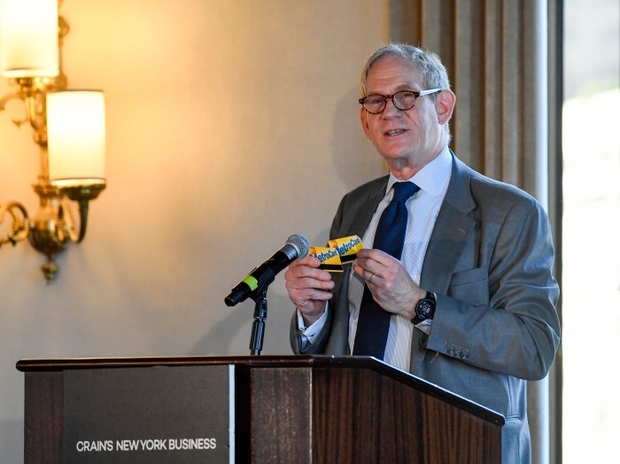 End of the line: MTA to end MetroCard sales by Dec. 31 to make room for OMNY 2 man at a podium holding MetroCards