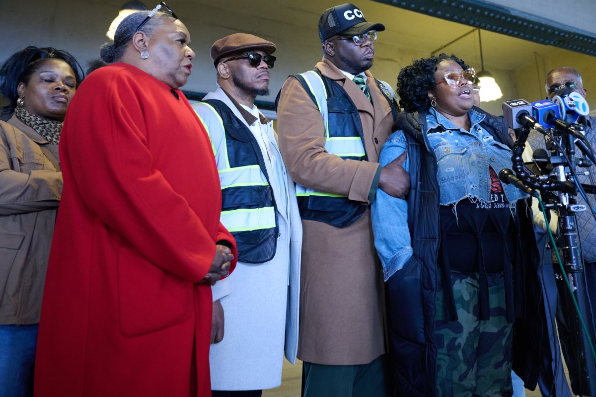 Rev, Kevin McCall  (left) stands with Monique Whyte who's son was assaulted at Stillwell Ave train station on Wednesday morning.