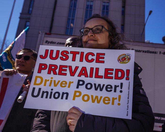 TLC drivers secure $140 million from city following court ruling about license suspensions and arrests 2 TLC driver holding a sign outside
