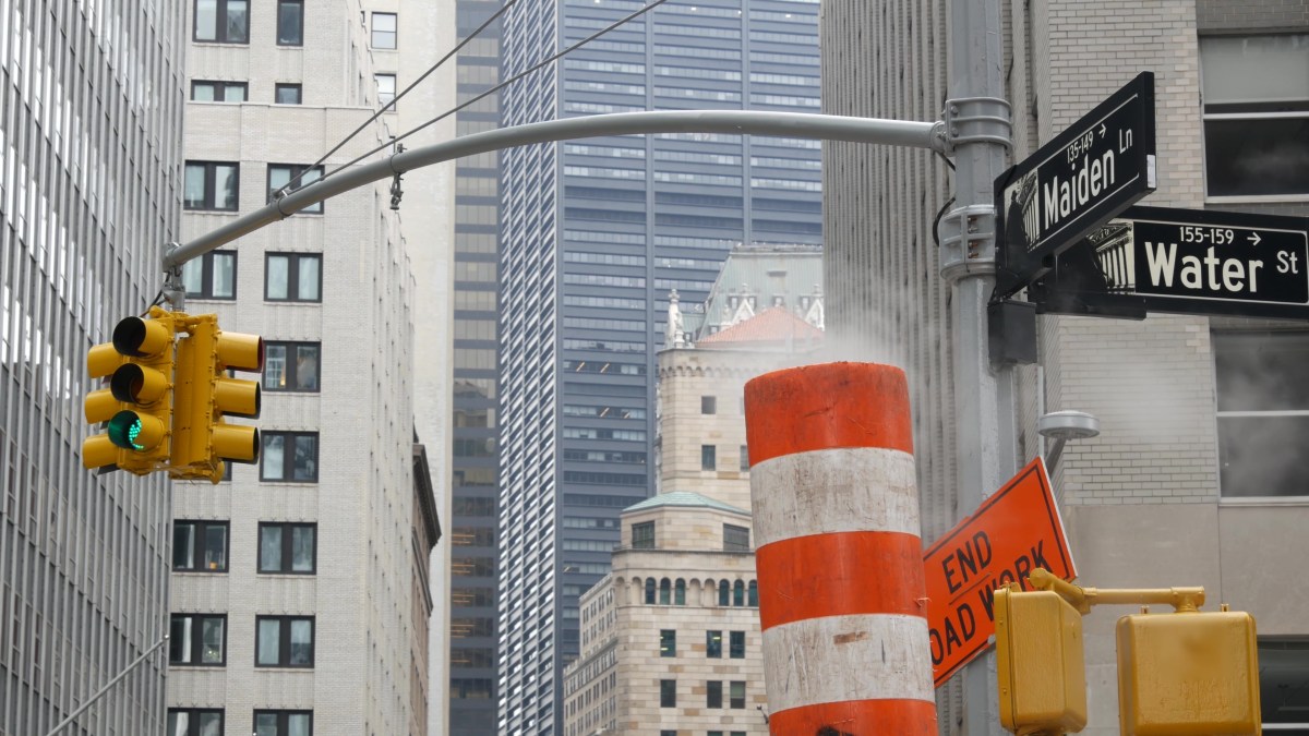Orange steamstack releasing vapor on Manhattan street