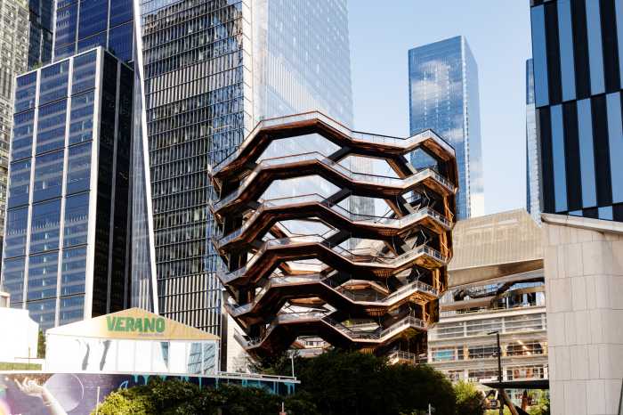 August 20th, 2024 - New York City, NY, USA: The Vessel architecture stands prominently in front of the other modern skyscrappers in Hudson Yards on a sunny afternoon in summer.