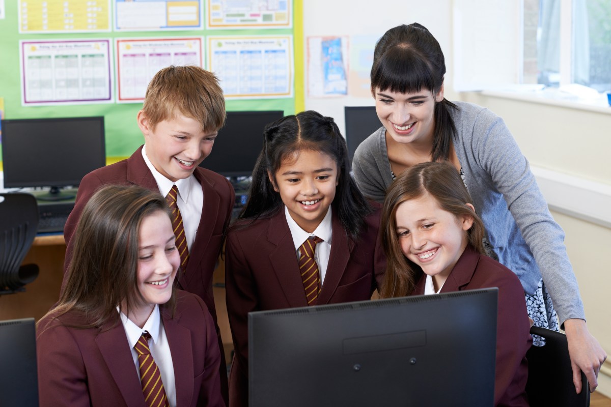 Students in nyc charter school classroom looking at computer