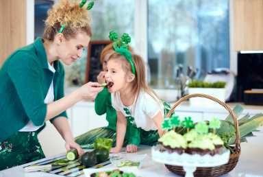 Mother with daughter cooking at kitchen