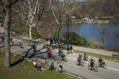 Bicyclists and people on Central Park roadway