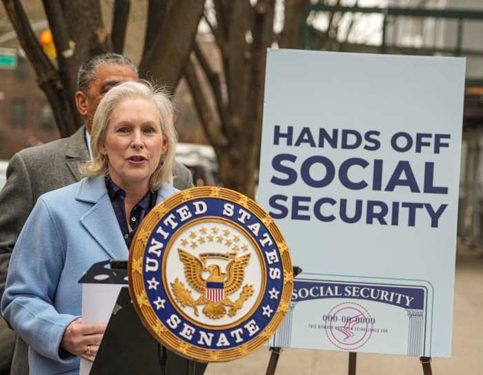 woman at a podium at a rally in New York to protect Social Security