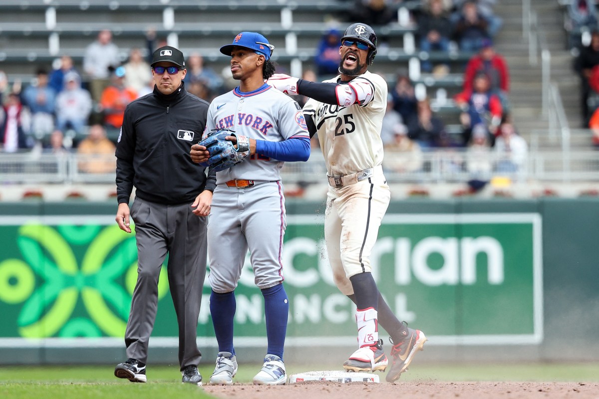 Mets player next to Twins player after double
