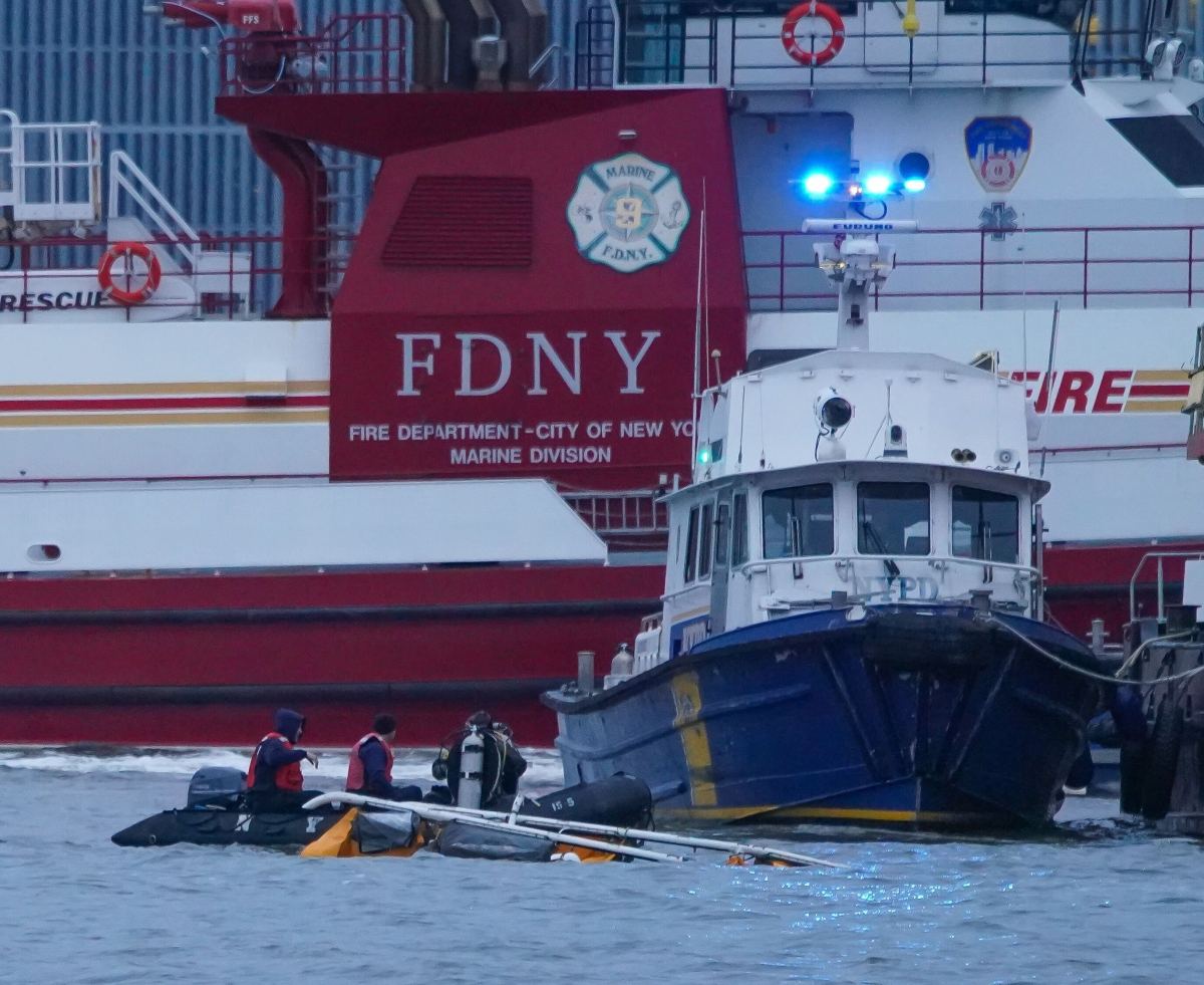 FDNY and NYPD drivers at the wreckage of a helicopter crash on the Hudson River on April 10, 2025.
