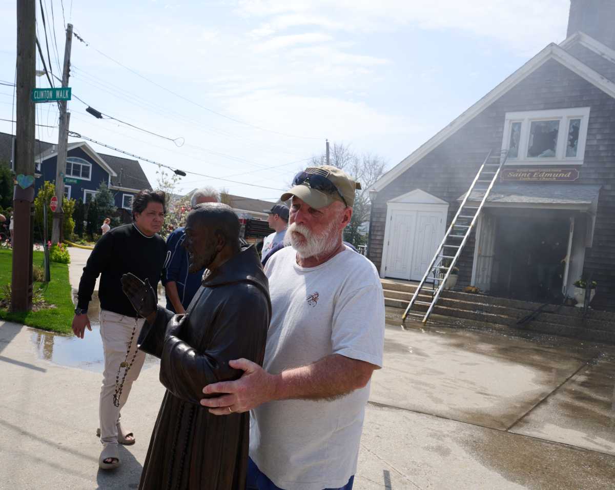 Parishioner carries statue out of Queens church during fire