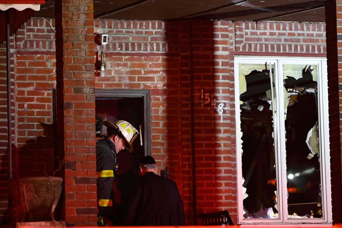 Firefighters work to remove windows from a second floor during a fire at 1585 Carroll St. in Brooklyn on April 4, 2025.