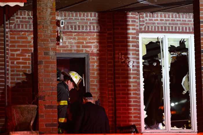 Firefighters work to remove windows from a second floor during a fire at 1585 Carroll St. in Brooklyn on April 4, 2025.