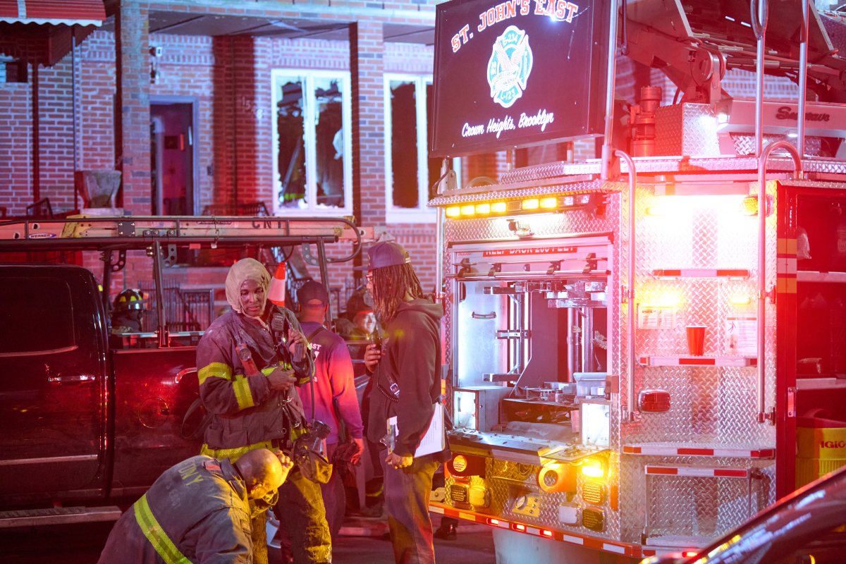 Firefighters work to remove windows from a second floor during a fire at 1585 Carroll St. in Brooklyn on April 4, 2025.