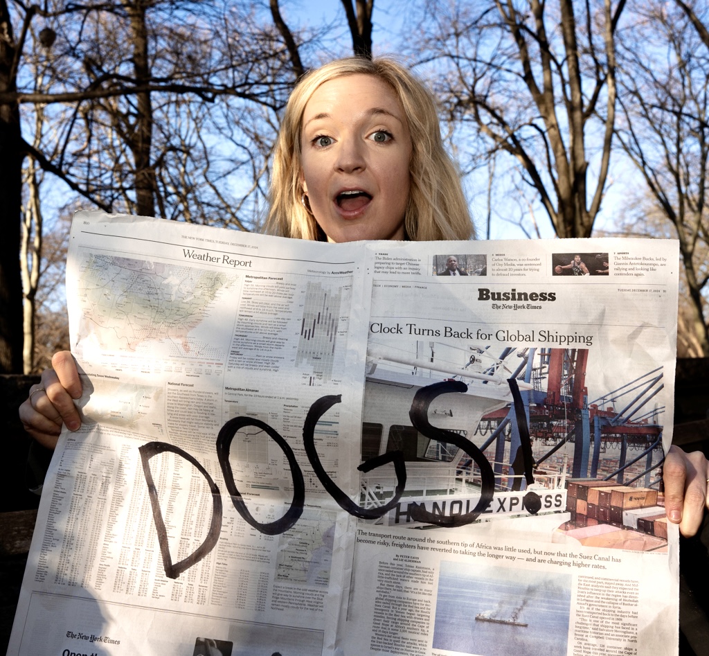 Fern Watt holding up paper with the word DOGS on it