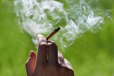 Marijuana joint in the hand, drugs concept for 4/20
