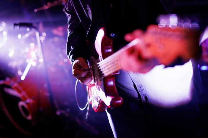 Close up of a musician playing the electric guitar during a concert