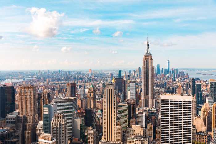 Iconic buildings overlooking bustling new york city with impressive architecture and vibrant energy in warm sunlight