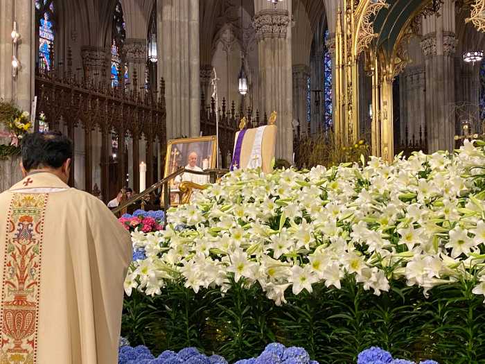 The alter of St Patrick's Cathedral bares a memorial for Pope Francis, including the char he sat upon during his 2015 visit to NYC