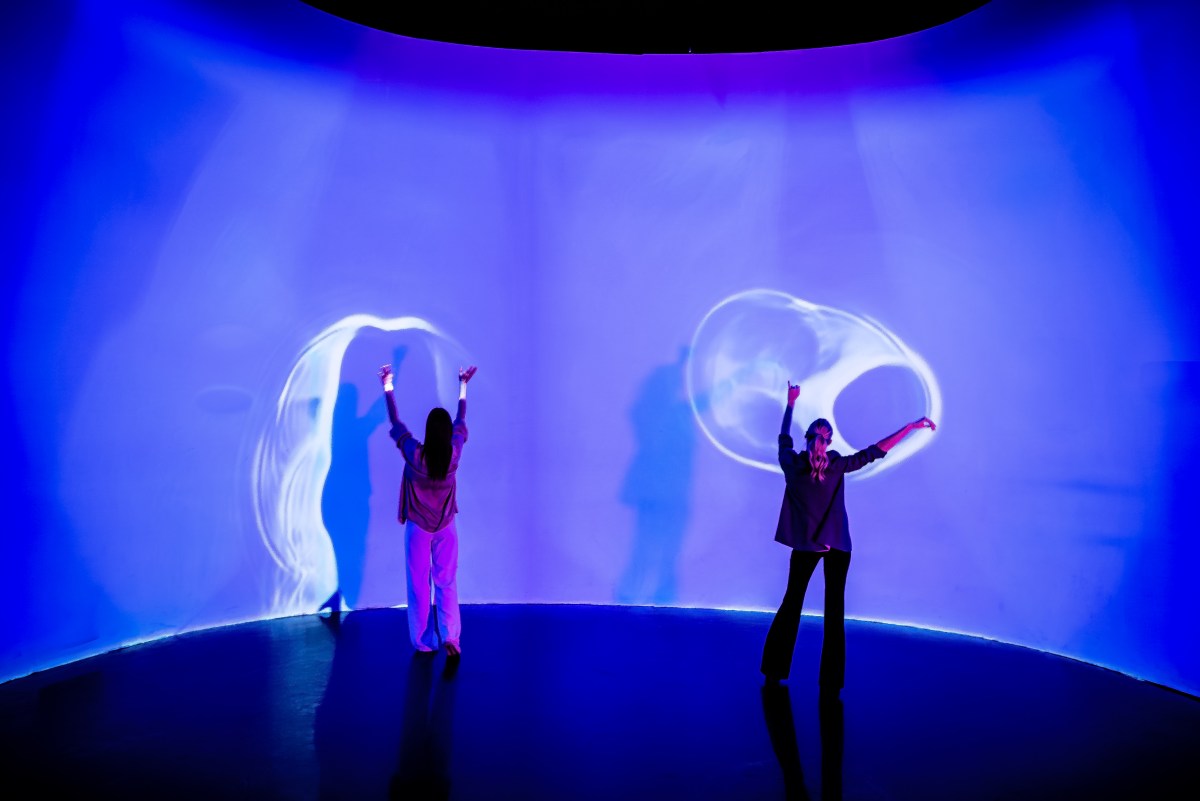 two guests interact with the latest INTER exhibit