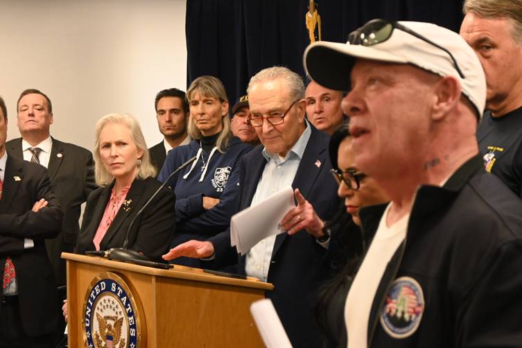 people at a podium during a rally for the WTC Health Program