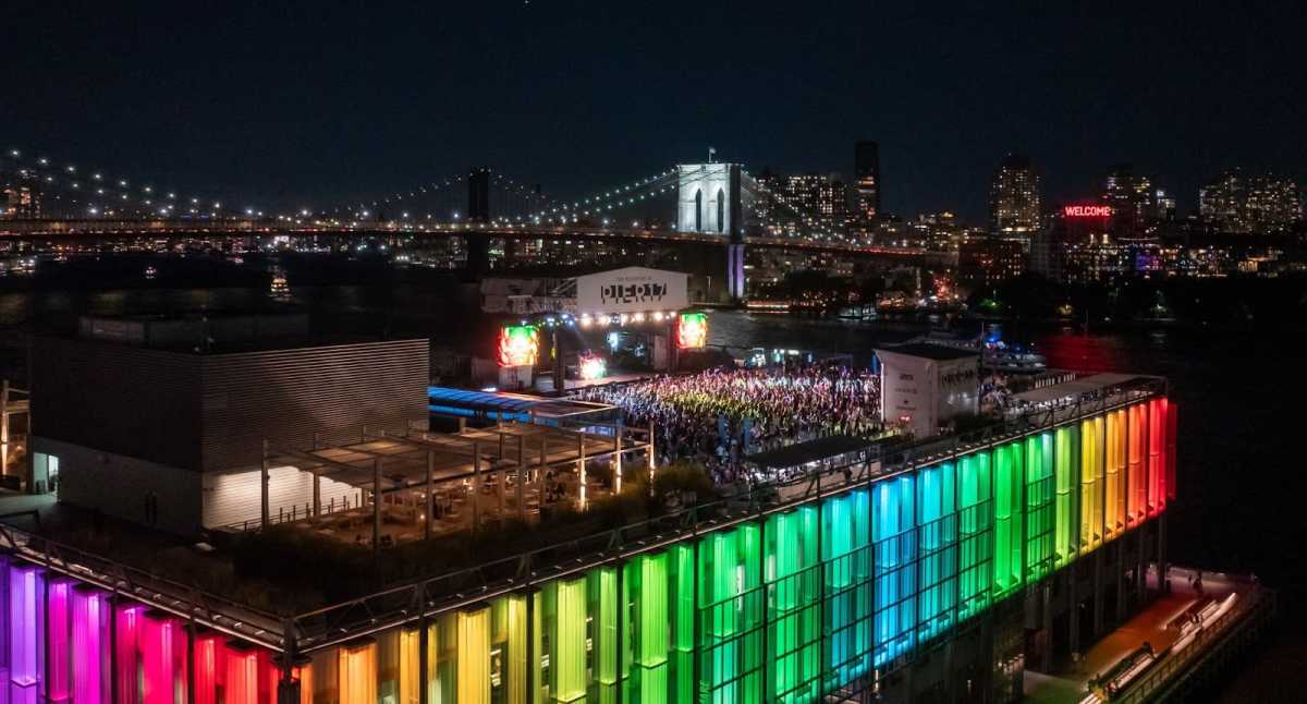 Rooftop at Pier 17 lit up in rainbow colors during concert