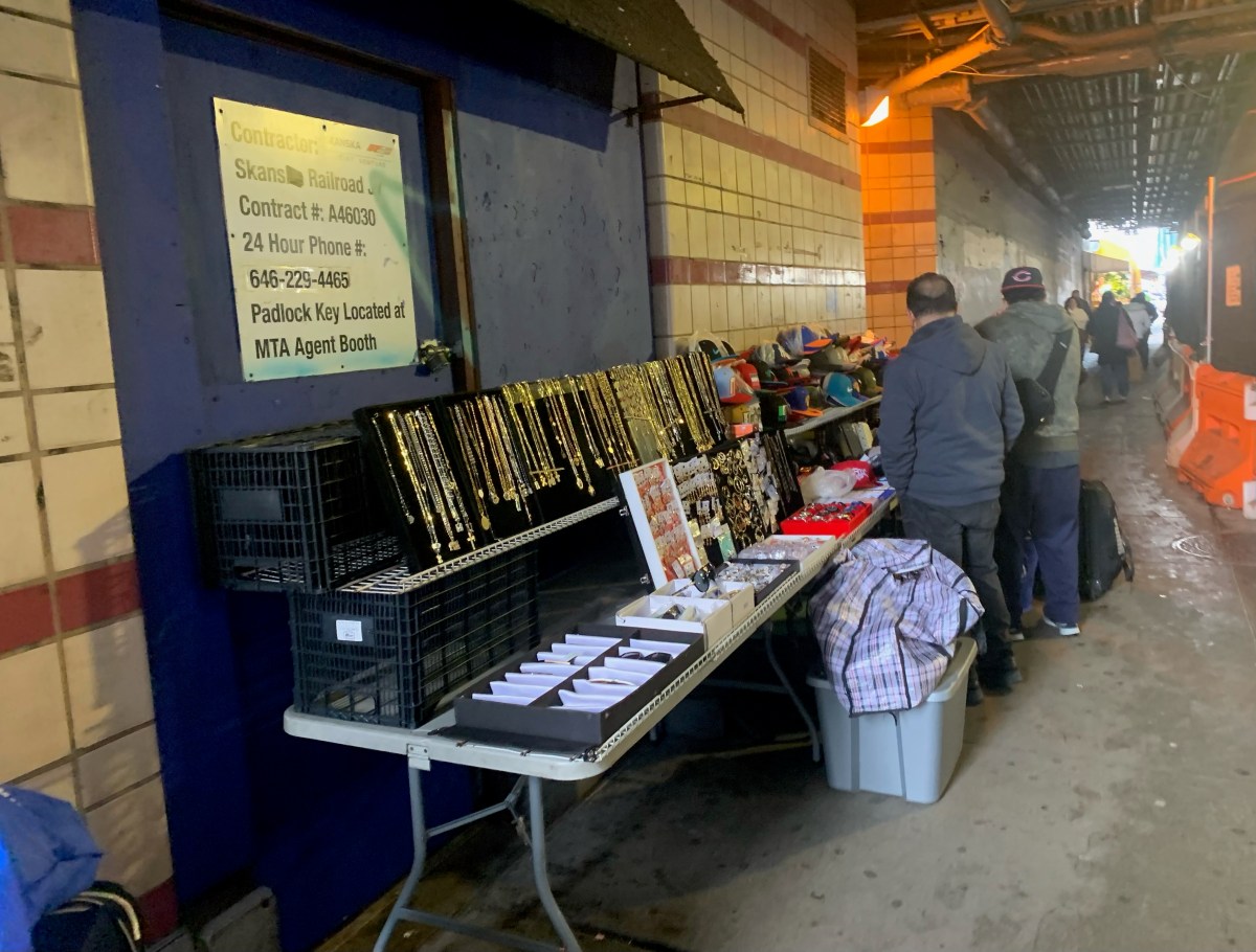outdoor vendor selling jewelry underneath one of many NYC subway stations