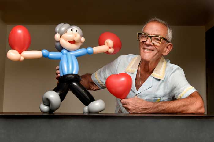 Balloon art aficionado Joel Klein with a portrait of himself