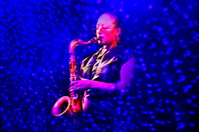 Sax player Nubya Garcia playing in a sea of blue dots