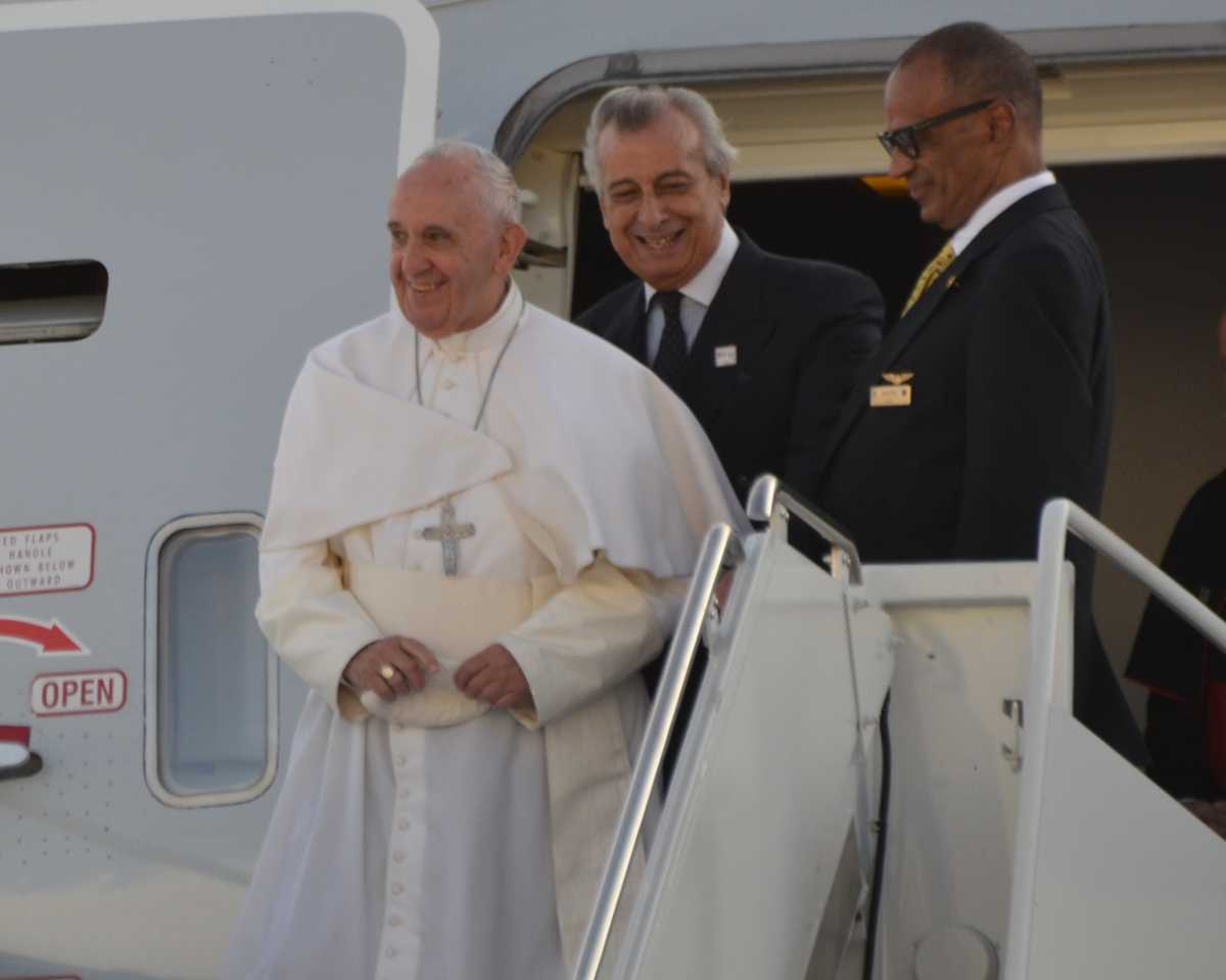 Pope Francis smiling as he departs a plane in New York