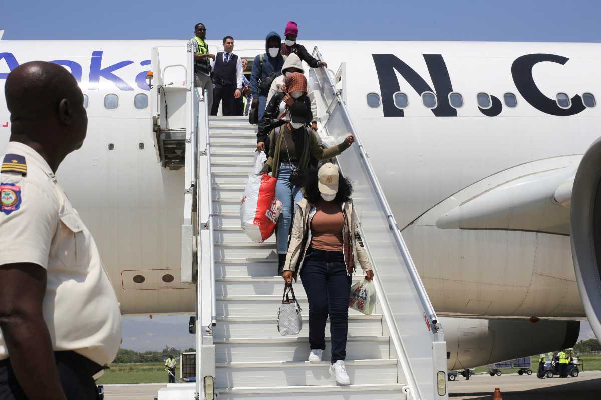 Haitian refugees departing an airplane
