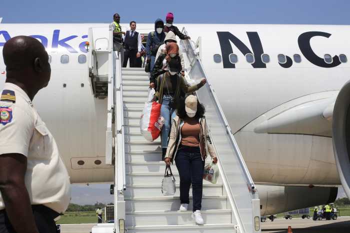 Haitian refugees departing an airplane
