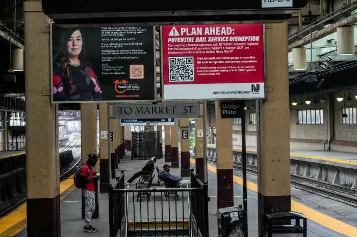 A notice reading: "Plan ahead: potential rail service disruption" is displayed as people look to commute at the Newark-Penn Station, after NJ Transit’s locomotive engineers went on strike at midnight in Newark, New Jersey, U.S., May 16, 2025. NJ transit engineers went on strike.