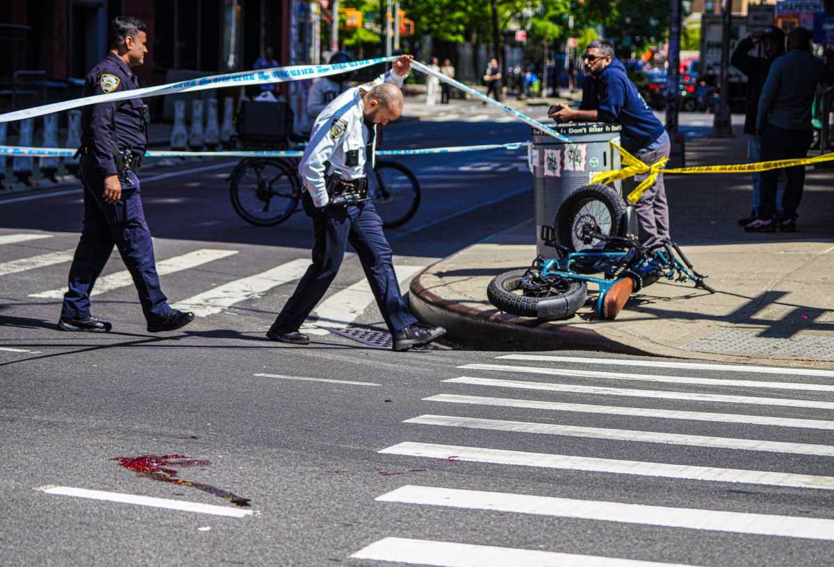 Police check scene where bicyclist was struck and killed by truck driver in Soho