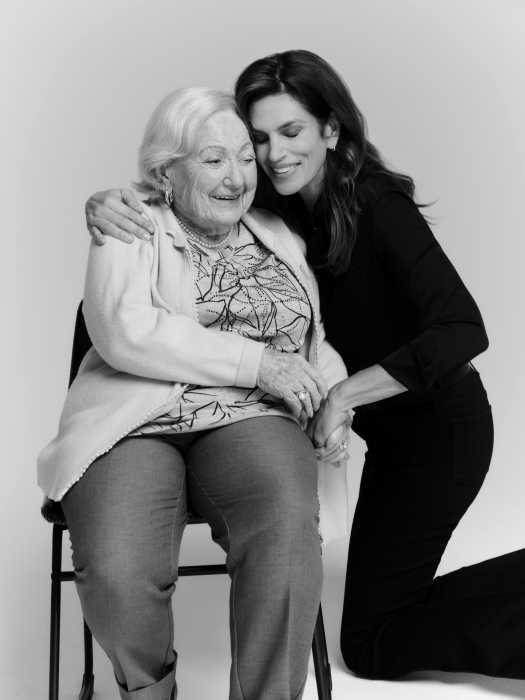 Cindy Crawford, Billy Porter, David Schwimmer and other celebs in new photo book that battles Holocaust misinformation 2 a woman sitting in a chair with another woman kneeling next to her