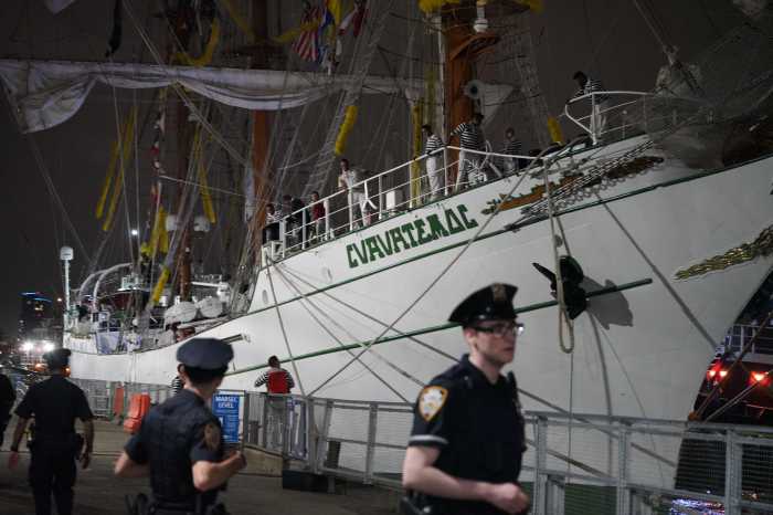 police officers at the site of a ship crash into the Brooklyn Bridge