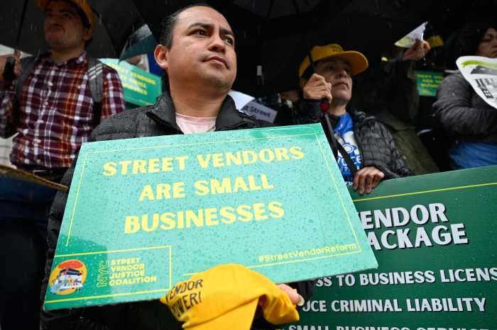 NYC street vendors and supporters rally at City Hall to demand long-delayed license reform: 'I want to do it legally, not illegally' 3 a street vendor holding a green sign in the rain