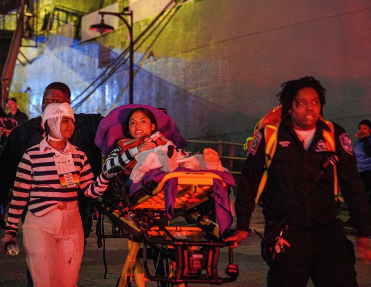 First responders rescue woman on stretcher after ship crashed into Brooklyn Bridge