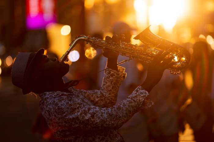New York City, USA - June 15, 2018: A street jazz musician performs during sunset in midtown Manhattan.