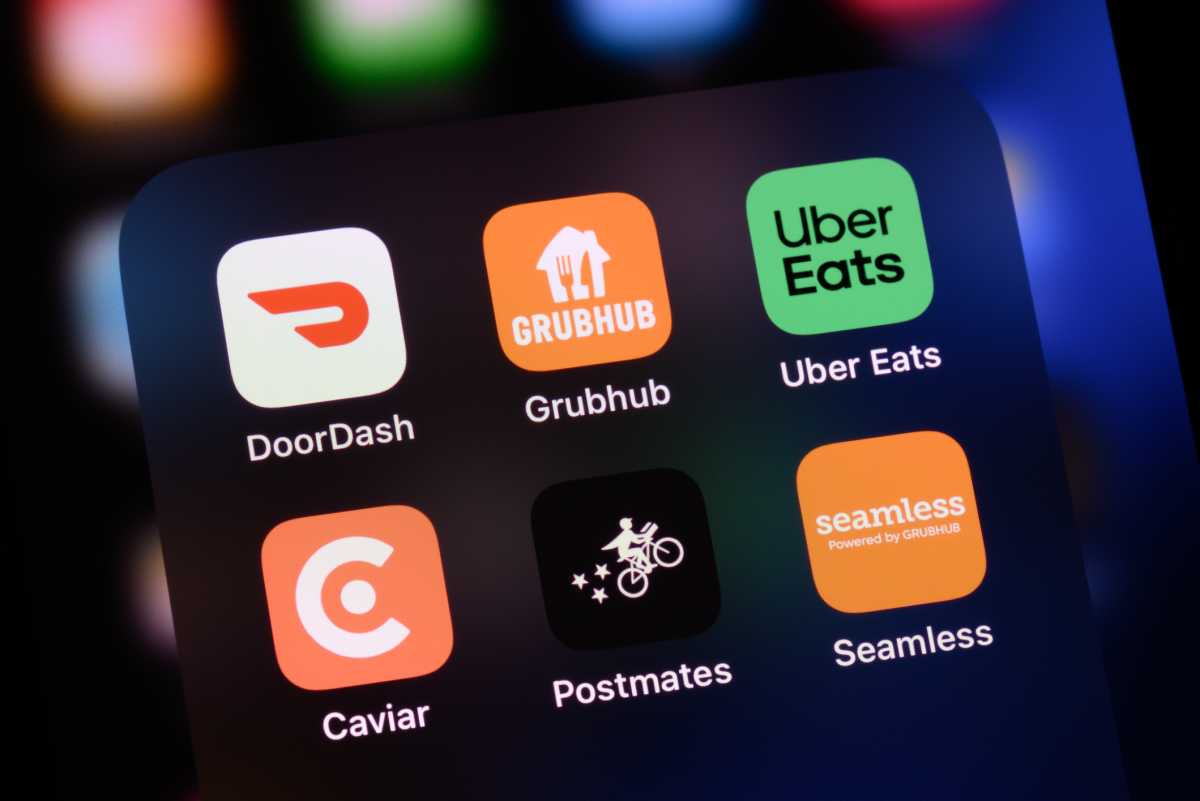 Toronto, Canada - December 14, 2023: Popular food delivery apps in United States on an Apple iPhone: DoorDash, GrubHub, Uber Eats, Caviar, Postmates, and Seamless.
