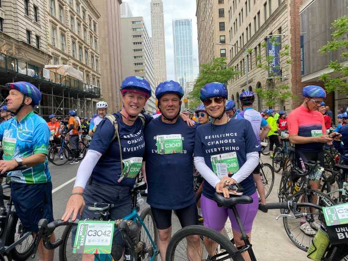 three people with bikes in a NYC street