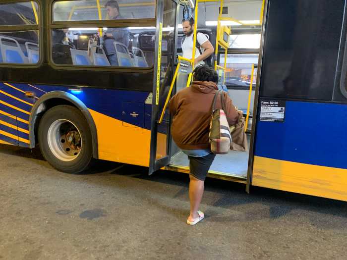 woman walking onto an MTA NYC bus
