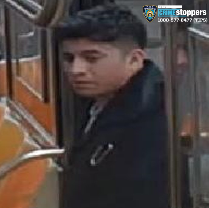 man wearing dark colored jacket entering a train