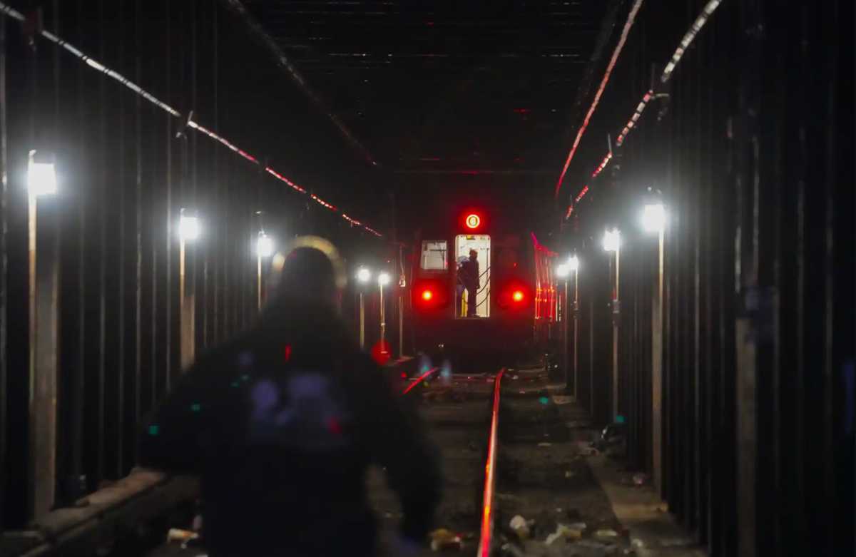 MTA audit on subway self-evacuations finds agency must do more to keep passengers in cars during delays 2 Man with subway train in background inside tunnel