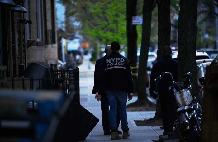 Police at a stabbing scene in Queens